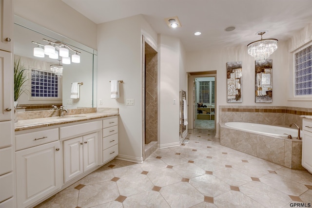 3835 S 179th Ter, Omaha, NE 68130 - bathroom with a chandelier, a bath, vanity, a stall shower, and recessed lighting
