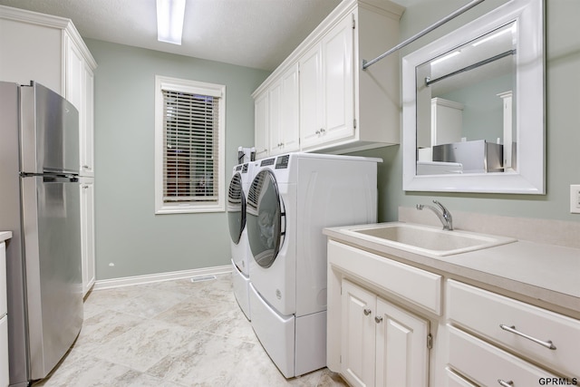 3835 S 179th Ter, Omaha, NE 68130 - laundry room with washer and dryer, cabinet space, and baseboards