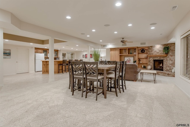 3835 S 179th Ter, Omaha, NE 68130 - dining space with a fireplace, light colored carpet, recessed lighting, a ceiling fan, and baseboards