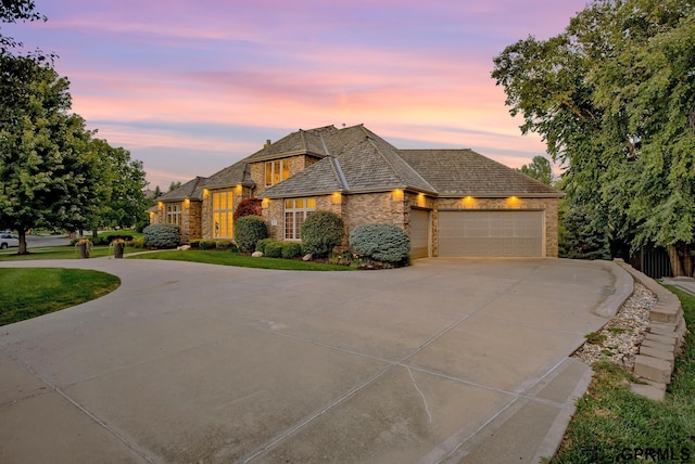 3835 S 179th Ter, Omaha, NE 68130 - french country style house with driveway, stone siding, and a garage