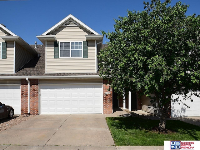 2023 Connor Pl, Lincoln, NE 68505 - view of front facade featuring brick siding, an attached garage, driveway, and roof with shingles