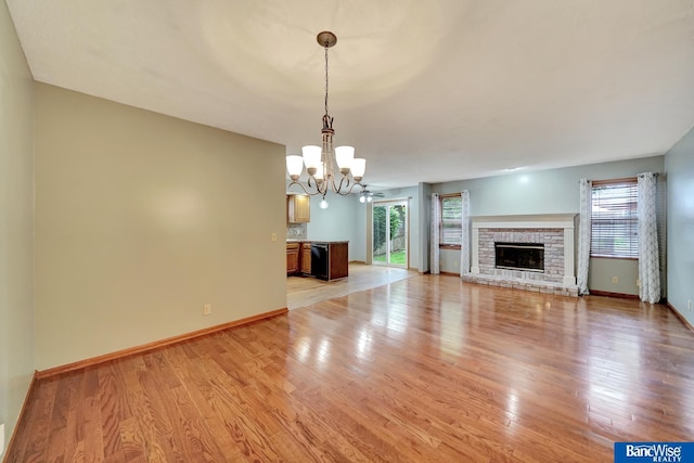 2727 N 75th St, Lincoln, NE 68507 - unfurnished living room with a chandelier, plenty of natural light, and light wood-style floors