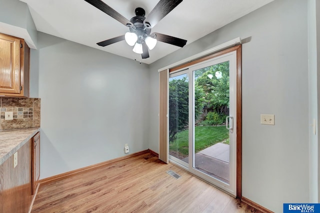 2727 N 75th St, Lincoln, NE 68507 - unfurnished dining area with light wood-style floors, ceiling fan, and baseboards