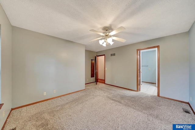 2727 N 75th St, Lincoln, NE 68507 - spare room with light colored carpet, a ceiling fan, baseboards, and a textured ceiling