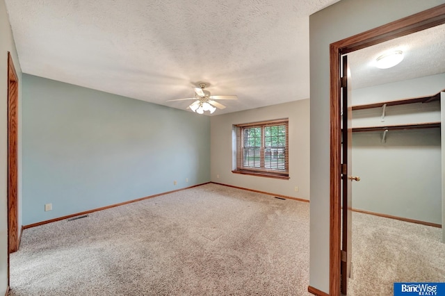 2727 N 75th St, Lincoln, NE 68507 - unfurnished bedroom with carpet flooring, a textured ceiling, baseboards, a ceiling fan, and a closet