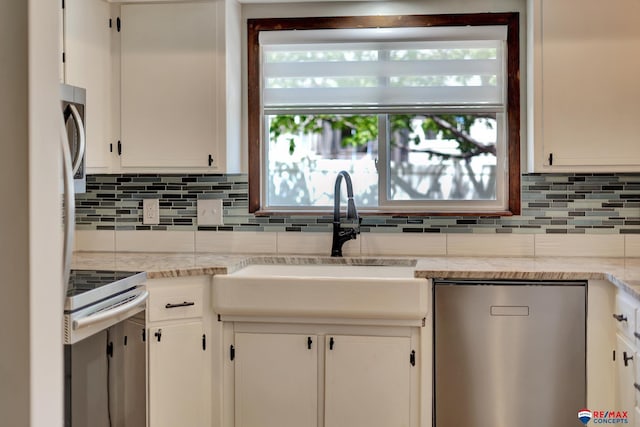 kitchen with range with electric stovetop, dishwasher, decorative backsplash, a sink, and white cabinetry