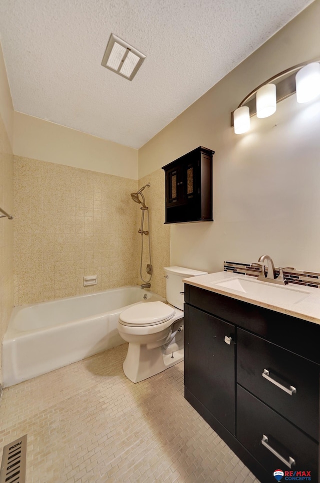 full bath featuring toilet, tub / shower combination, vanity, and a textured ceiling