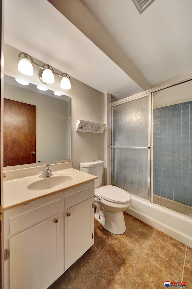 bathroom with an enclosed shower, toilet, vanity, and tile patterned floors