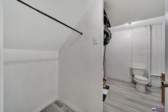 bathroom with toilet and wood finished floors