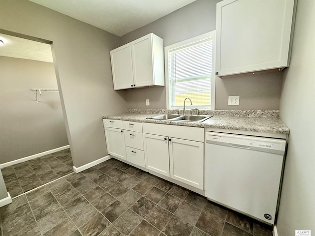 4227 N 57th St, Lincoln, NE 68507 - kitchen featuring dishwasher, a sink, baseboards, white cabinetry, and light countertops