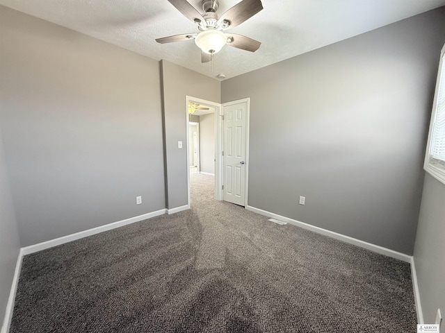 4227 N 57th St, Lincoln, NE 68507 - empty room featuring a ceiling fan, baseboards, carpet, and a textured ceiling