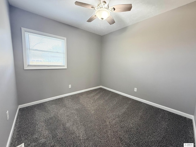4227 N 57th St, Lincoln, NE 68507 - unfurnished room featuring baseboards, a ceiling fan, and dark carpet