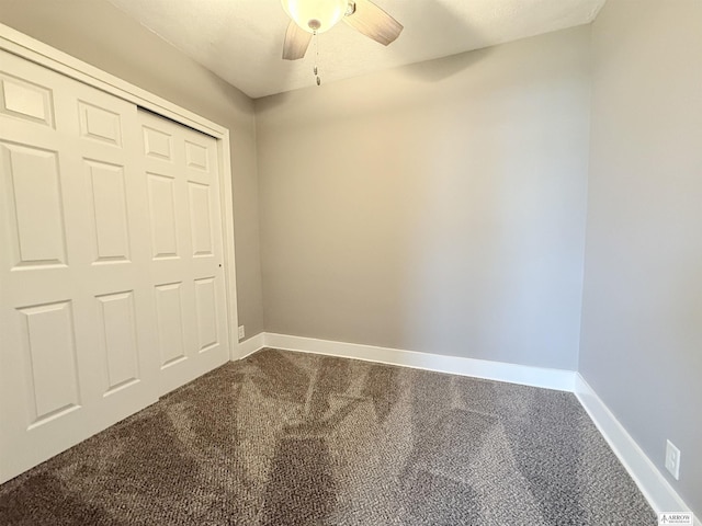 4227 N 57th St, Lincoln, NE 68507 - unfurnished bedroom with dark colored carpet, baseboards, and ceiling fan