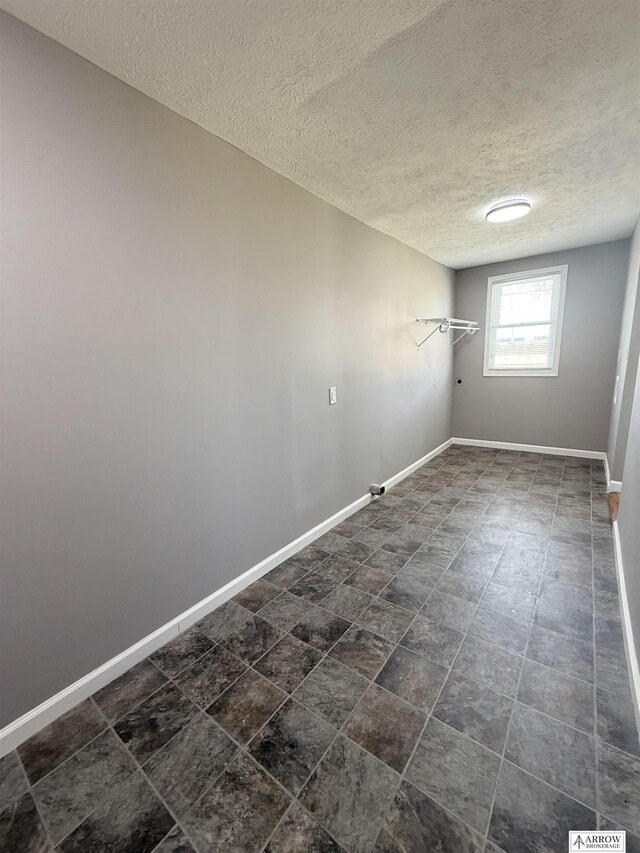 4227 N 57th St, Lincoln, NE 68507 - below grade area with a textured ceiling and baseboards