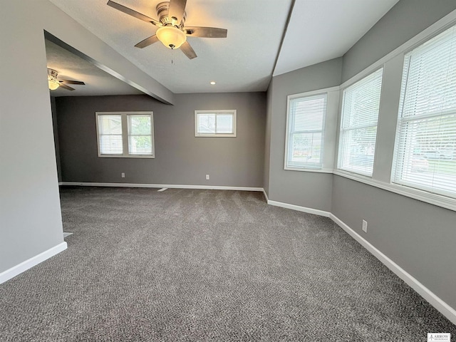 4227 N 57th St, Lincoln, NE 68507 - unfurnished room featuring ceiling fan, baseboards, and dark carpet