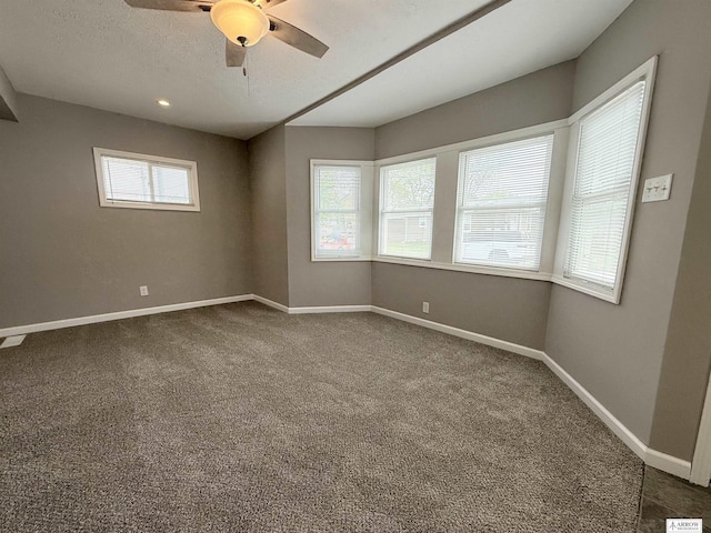 4227 N 57th St, Lincoln, NE 68507 - unfurnished room with dark carpet, a ceiling fan, and baseboards