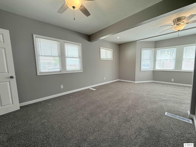 4227 N 57th St, Lincoln, NE 68507 - empty room with a ceiling fan, carpet flooring, baseboards, and beamed ceiling