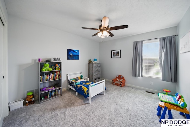 bedroom featuring carpet, baseboards, and a ceiling fan