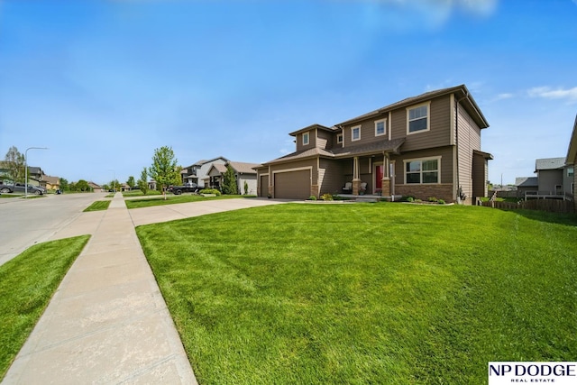 view of front of home with a front lawn, concrete driveway, and brick siding