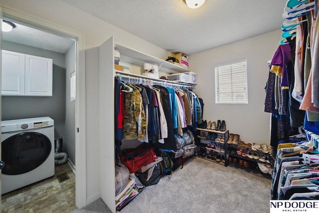 walk in closet featuring washer / clothes dryer and carpet flooring