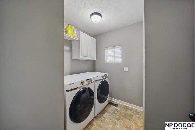 washroom featuring independent washer and dryer, cabinet space, baseboards, and a textured ceiling