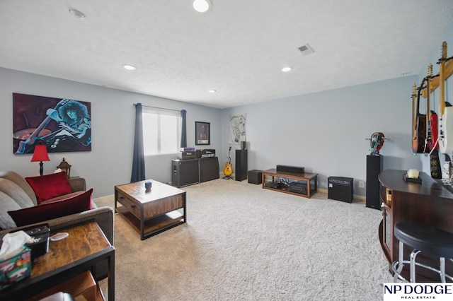 carpeted living area with recessed lighting