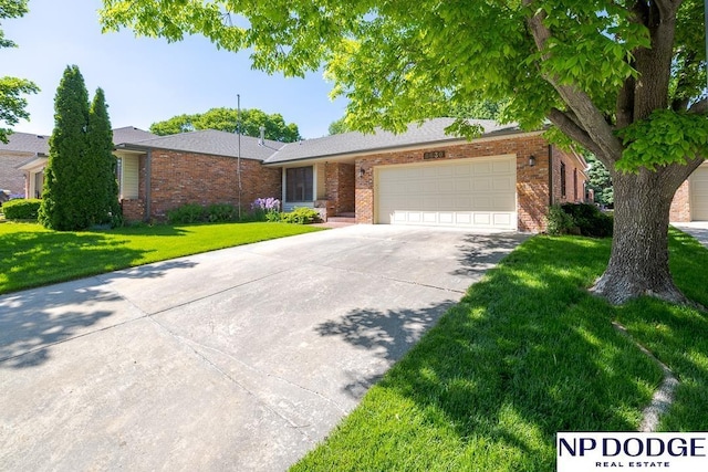 6630 Flint Ridge Rd, Lincoln, NE 68506 - single story home featuring brick siding, a garage, driveway, and a front yard