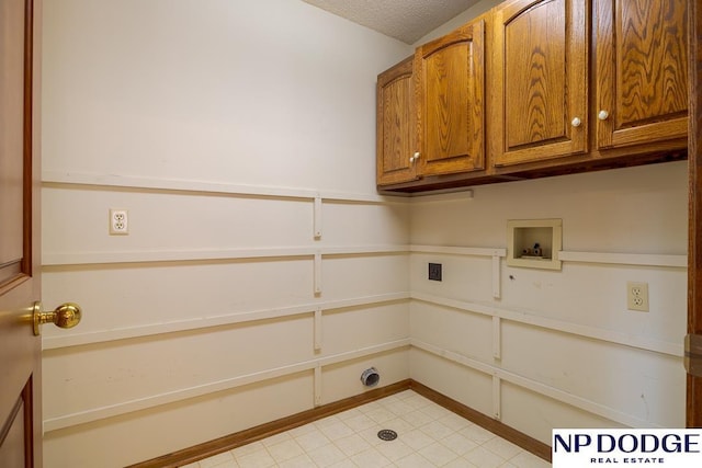 6630 Flint Ridge Rd, Lincoln, NE 68506 - laundry area with cabinet space, hookup for a washing machine, a textured ceiling, and light tile patterned floors