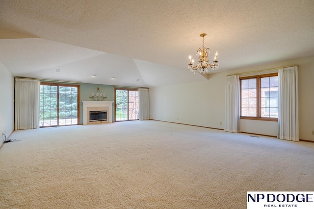 6630 Flint Ridge Rd, Lincoln, NE 68506 - unfurnished living room with light colored carpet, vaulted ceiling, a chandelier, a glass covered fireplace, and baseboards