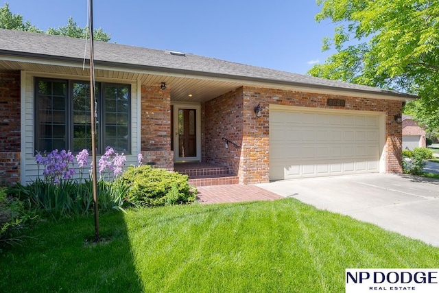 6630 Flint Ridge Rd, Lincoln, NE 68506 - single story home with brick siding, concrete driveway, a front yard, and a garage