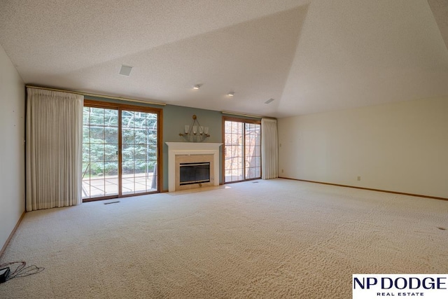 6630 Flint Ridge Rd, Lincoln, NE 68506 - unfurnished living room with carpet, a glass covered fireplace, baseboards, and a textured ceiling