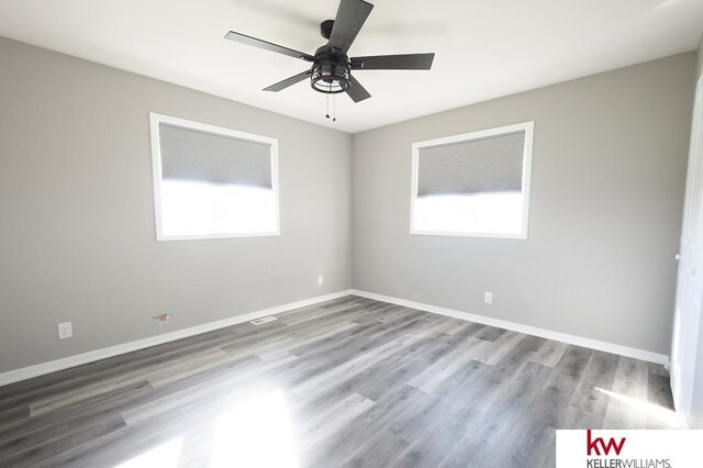 56420 708th Rd, Fairbury, NE 68352 - spare room with wood finished floors, ceiling fan, and baseboards