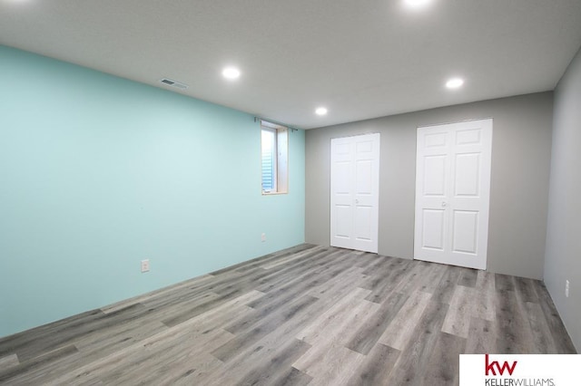 56420 708th Rd, Fairbury, NE 68352 - unfurnished bedroom with wood finished floors, recessed lighting, and a closet