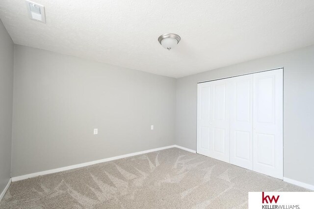 56420 708th Rd, Fairbury, NE 68352 - unfurnished bedroom with carpet floors, baseboards, and a closet