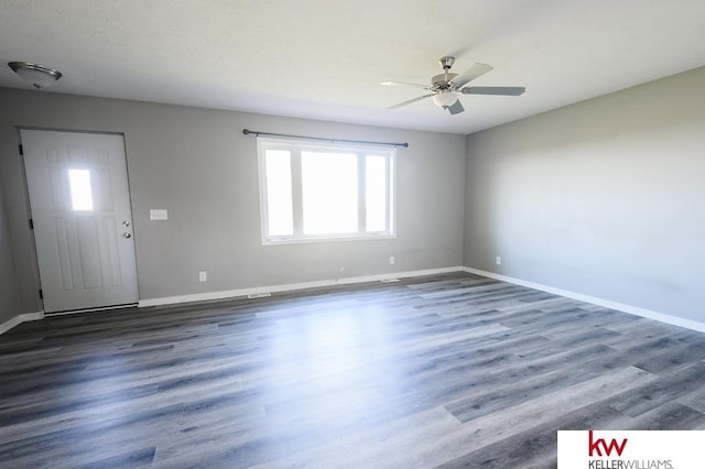 56420 708th Rd, Fairbury, NE 68352 - empty room featuring plenty of natural light, ceiling fan, baseboards, and wood finished floors