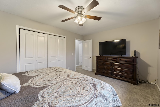 carpeted bedroom with a closet, ceiling fan, and baseboards