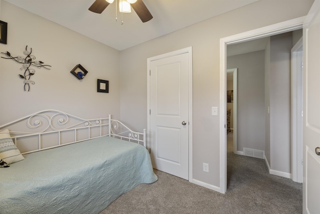 carpeted bedroom with baseboards and a ceiling fan