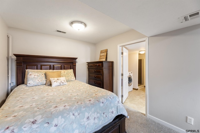 bedroom featuring washer / clothes dryer, light carpet, and baseboards