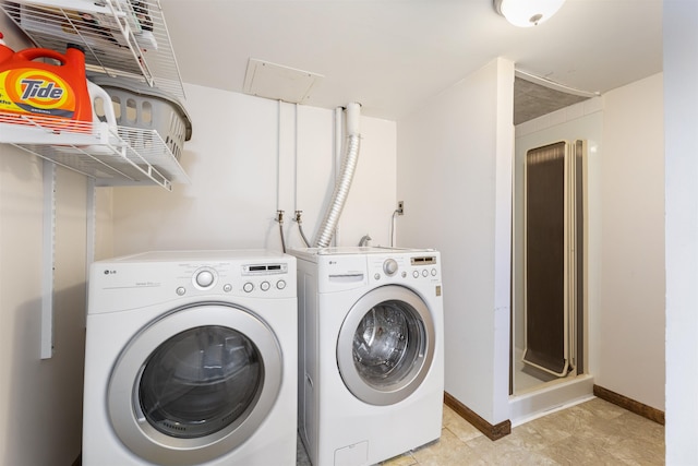 washroom featuring separate washer and dryer and baseboards