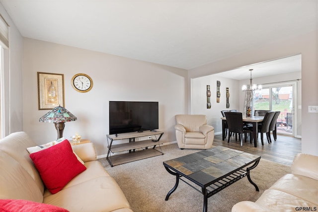 living room with a chandelier and baseboards
