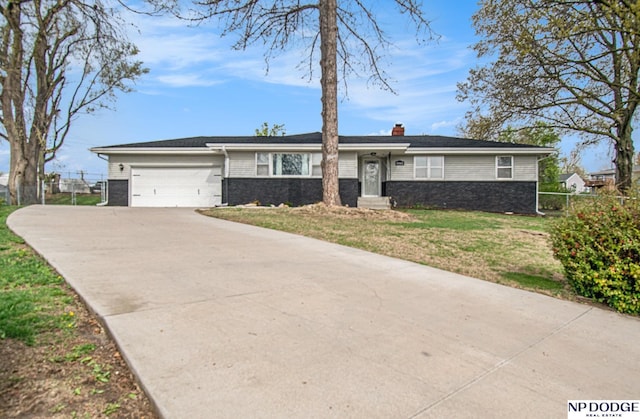 ranch-style home featuring a chimney, driveway, and a garage