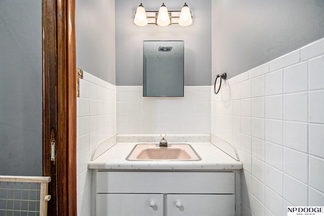 bathroom with tile walls and vanity