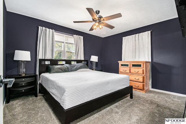 carpeted bedroom with baseboards and a ceiling fan