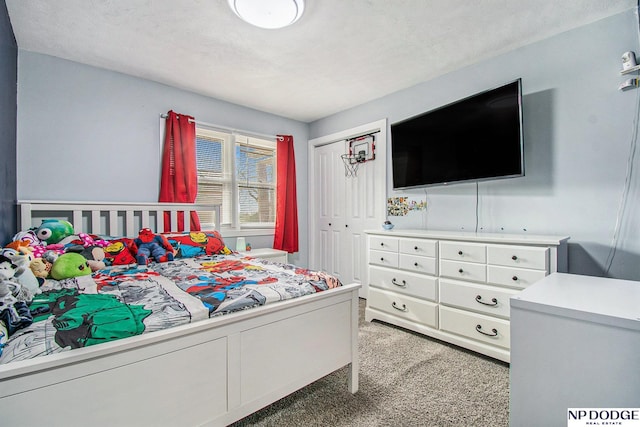 bedroom featuring light colored carpet and a closet