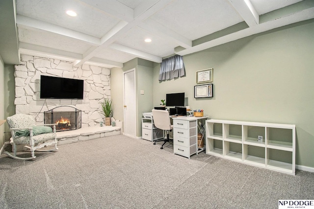 carpeted office space with beamed ceiling, a stone fireplace, recessed lighting, coffered ceiling, and baseboards