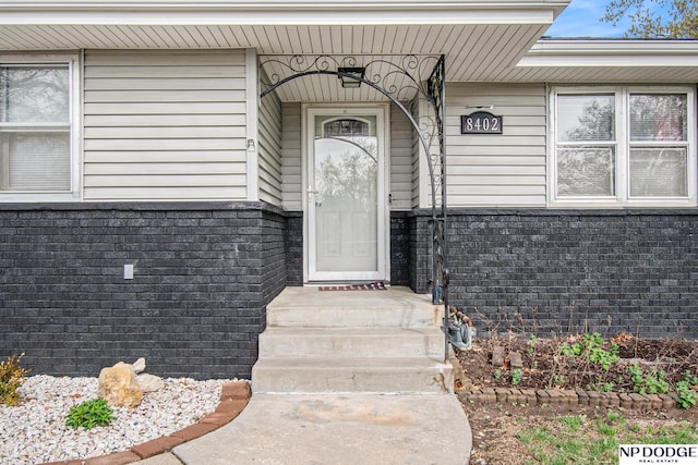 property entrance with brick siding