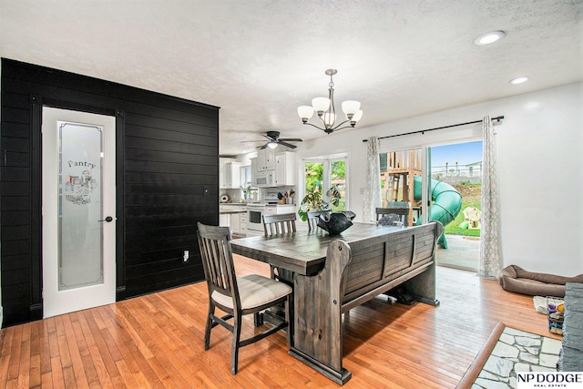 dining room with a chandelier, light wood-type flooring, a textured ceiling, ceiling fan, and recessed lighting
