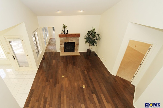 6427 Lone Tree Dr, Lincoln, NE 68512 - unfurnished living room with a fireplace, healthy amount of natural light, dark wood-style flooring, and baseboards