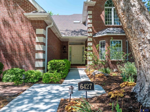 6427 Lone Tree Dr, Lincoln, NE 68512 - entrance to property with roof with shingles and brick siding