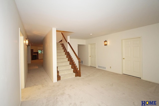 6427 Lone Tree Dr, Lincoln, NE 68512 - unfurnished living room featuring stairs and light carpet